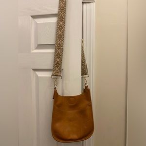 Used Ah-dorned tan cross body purse with strap in great condition.